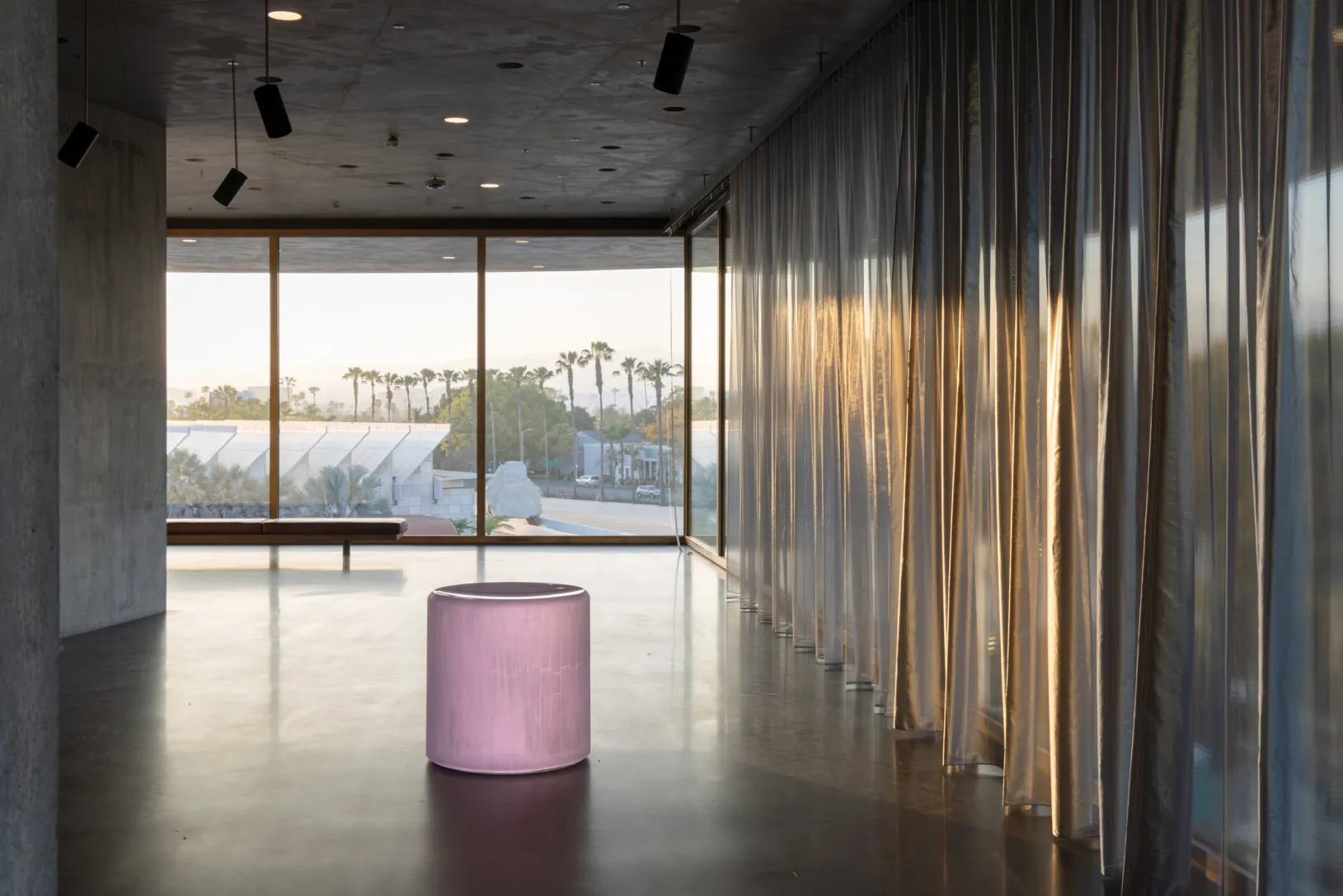 <p>Interior of the David Geffen Galleries at LACMA with Roni Horn's <em>Untitled ("The sensation of satisfaction at having outstared a baby.") </em>(2012–13)&nbsp;in the foreground and Michael Heizer's <em>Levitated Mass</em> (2012) in the background, © Roni Horn, © Michael Heizer, photo © Iwan Baan</p>