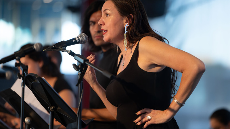 Photo of a woman performing with a microphone