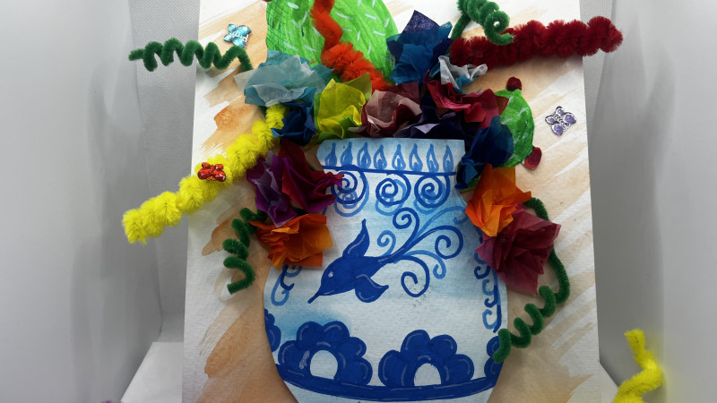 A arts and craft of a paper vase with pipe cleaners as flowers.