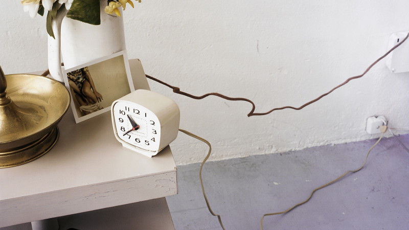 Clock and Photograph on a Nightstand