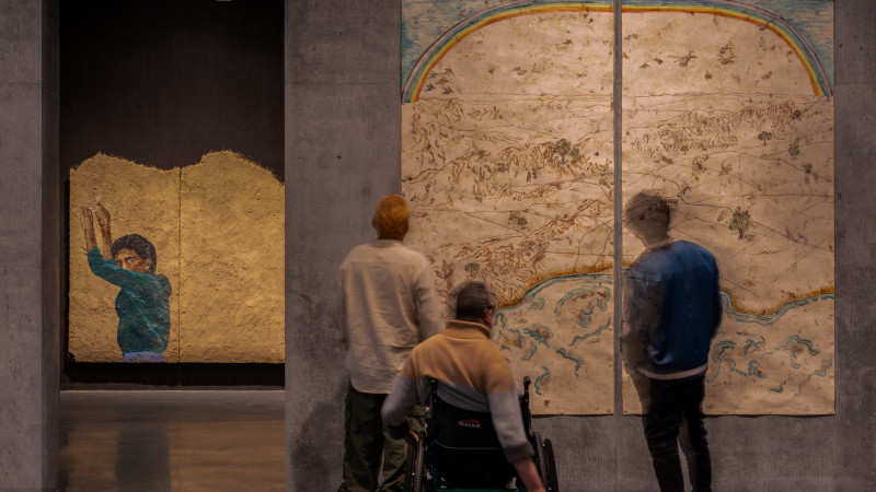 Photo of people and artworks in gallery