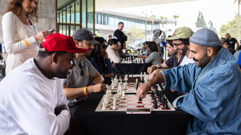 Photo of people playing chess at tables