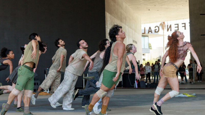 Photo of seven dancers leaning forward in motion