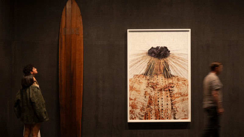 Photo of gallery with people and artworks