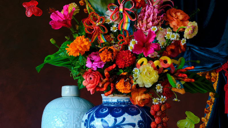 Photo of vases with flowers, candy, and fruit