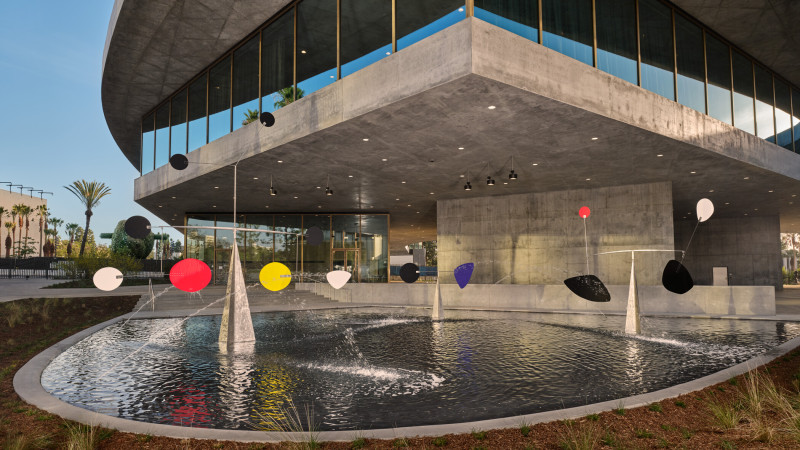 Photo of sculpture and fountain outside concrete building