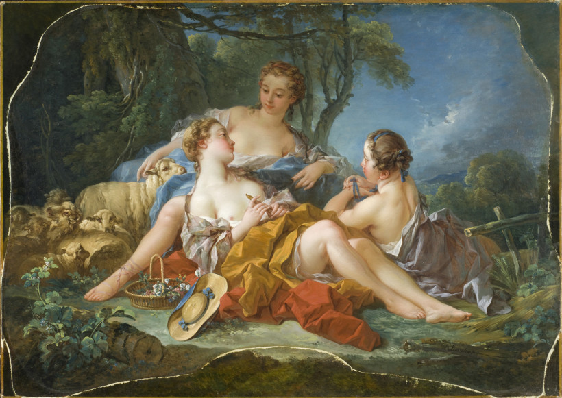 Oil painting of three young women reclining outdoors in loose draped garments, one partially bathed in light holding a bird, sheep nearby, flower basket and straw hat on the ground.