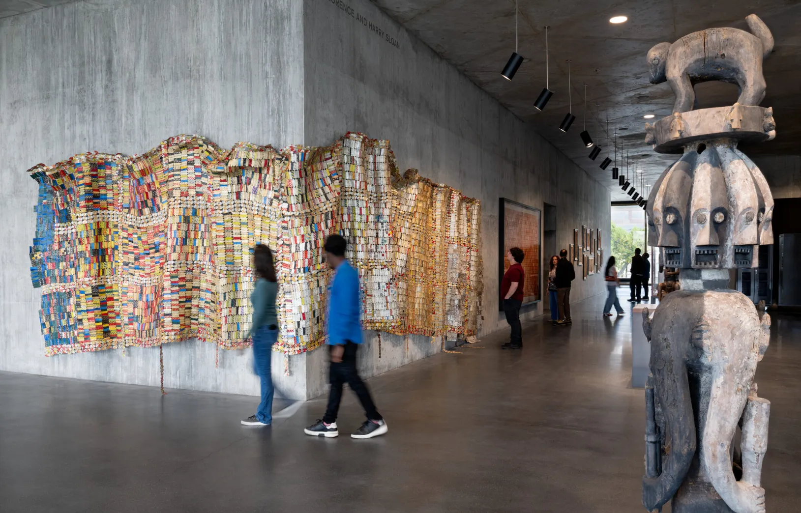 <p>Visitors in the David Geffen Galleries with El Anatsui's <em>Fading Scroll</em>, 2007, Los Angeles County Museum of Art, Los Angeles County Museum of Art and the Fowler Museum, UCLA, purchased jointly with funds provided by The Broad Art Foundation, Phil Berg, Mary and Robert Looker, and Margaret Pexton Murray, © El Anatsui, photo © Museum Associates/LACMA, by Charles Powers</p>