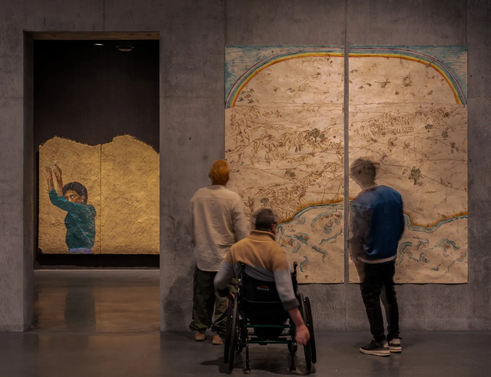 <p>Visitors in the David Geffen Galleries with rafa esparza's <em>...we are the mountain</em>, 2019, and Sandy Rodriguez's <em>Rainbows, Grizzlies, and Snakes, Oh My! - Conquest to Caging in Los Angeles</em>, 2019, Los Angeles County Museum of Art, © rafa esparza, © Sandy Rodriguez, photo © Museum Associates/LACMA, by Kristina Simonsen&nbsp;</p>
