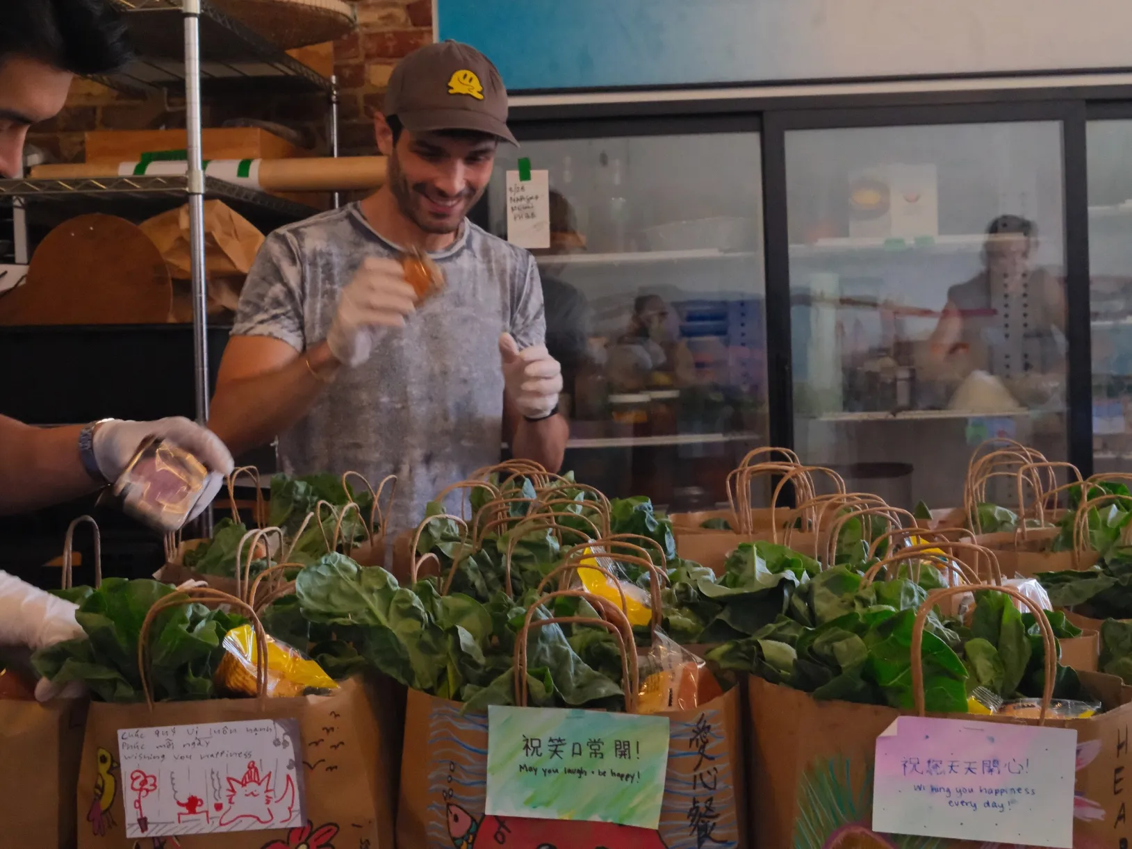 <p>Heart of Dinner volunteers Micky Shiloah and Eddie Liu with care packages, photo courtesy Heart of Dinner</p>