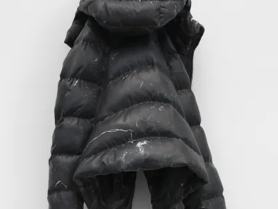 Marble sculpture carved to resemble a puffer jacket with hood, wrinkled fabric folds, and zipper rendered in black stone with visible white veining.